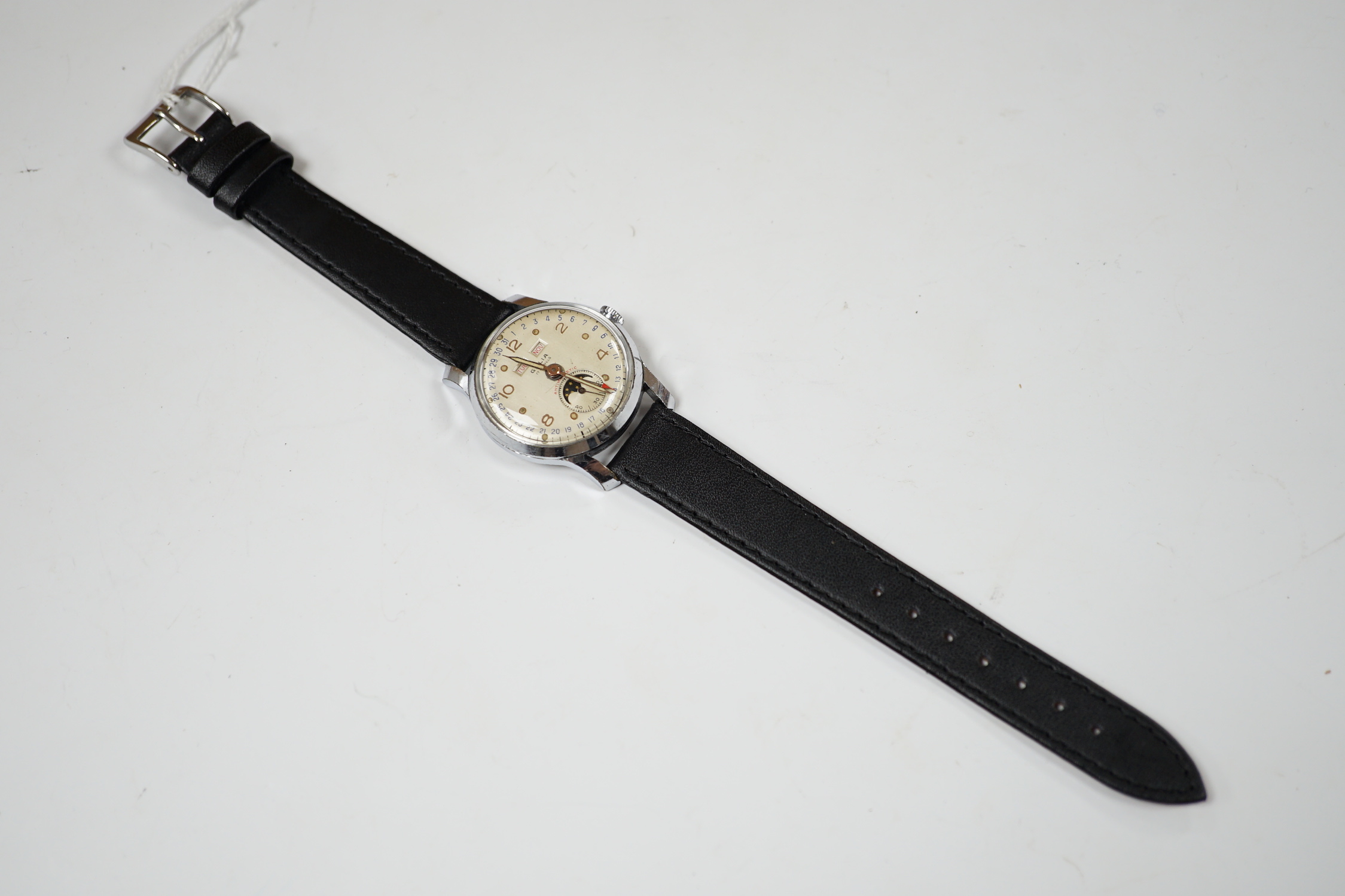 A gentleman's 1950's? stainless steel Galia calendar moonphase manual wind wrist watch, on an associated leather strap, case diameter 32mm.